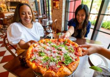 Friends grabbing pizza at B.B. Italia