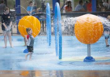 Toddler enjoying splash pad at Constellation Field In Sugar Land, TX