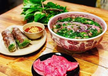 Pho soup with vermicelli noodles and spring rolls