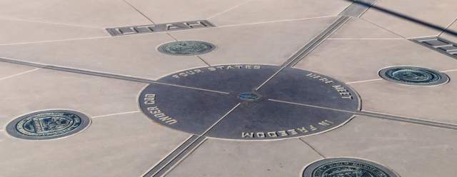 A bronze plaque on the ground showing the four corners of New Mexico