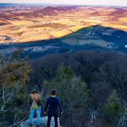 Hikers look out over the view from the Pinnacle