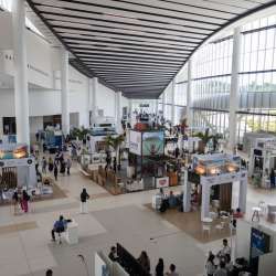 Panama Convention Center, a modern and spacious building with large windows and a sleek design.  It is located on the Amador Causeway, offering stunning views of the Pacific Ocean and the Bridge of the Americas.
