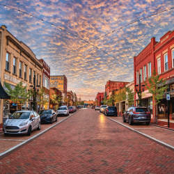 Trade Street in downtown Greer, SC looks idyllic with strung lights and old-timey shops and buildings.