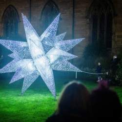 A large bright star shaped installation which has white and black colours.