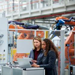 Two people in an advanced manufacturing factory