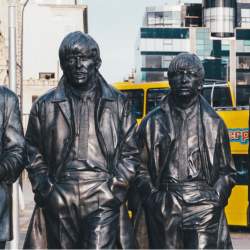Four larger than life, realistic statues of the Beatles