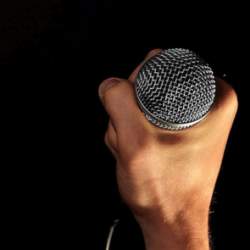 A microphone being held in the dark