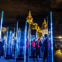 Mirrored monoliths on Liverpool's Pier Head in the dark. The Royal Liver Building can be seen in the background