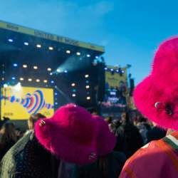 Two pink, furry bucket hats worn by people at the Eurovision Village stage