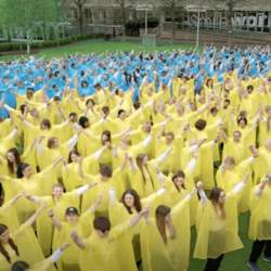 People in yellow and blue ponchos in a formation of a Ukrainian flag