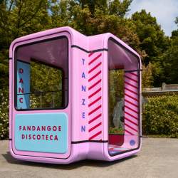 A booth similar in style to a photo booth that contains a portable disco.