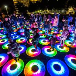 Colourful rings on the floor that are lit up with people walking on them