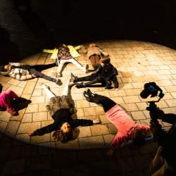 Children lying in a spotlight