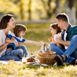 A young family enjoying a picnic in the park