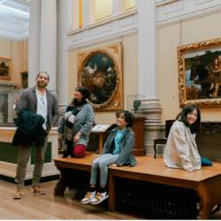 Family looking at paintings in ornate frames at Lady Lever Art Gallery, Port Sunlight