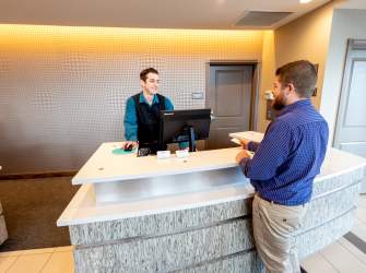 Man at Hotel Reception Desk