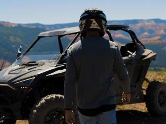 An off highway vehicle tour guide walks toward a vehicle at the High Mountain Overlook in Brian Head, Utah.
