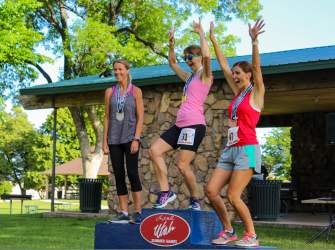 Three women celebrate their medals at the Utah Summer Games in Cedar City, Utah.