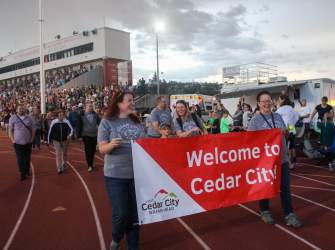 Our visitor center team dressed in matching Cedar City t-shirts walks in the athlete parade at the Utah Summer Games Opening Ceremonies.