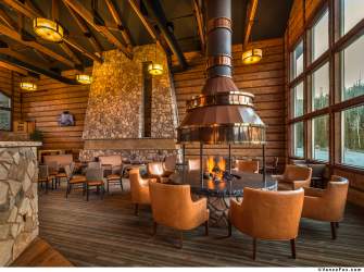 Tables gathered around an indoor firepit in the Brian Head Lodge.