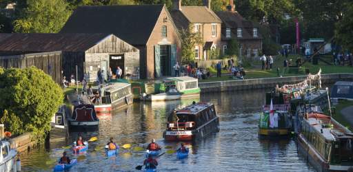 People take part in a pageant on the River Wey and Godalming Navigations,