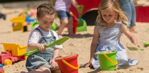 Children enjoying outdoor fun in the sand pits at Godstone Farm