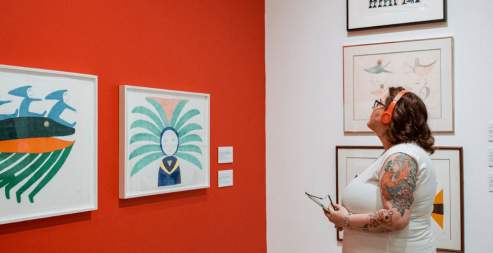 woman in headphones looking at art