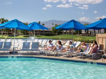 Friends lounging poolside at the JW Marriott Desert Springs