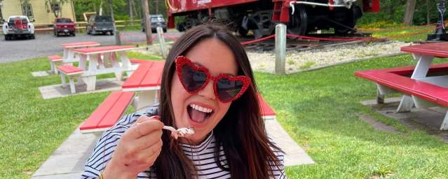 Woman eating a banana split at the Caboose Food & Ice Cream in Madison Twp, PA