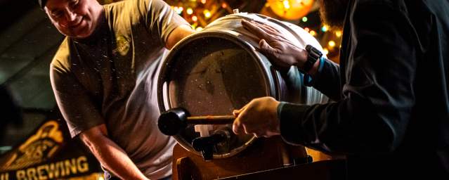 men opening a beer keg at Brewfest at Montage Mountain Resorts