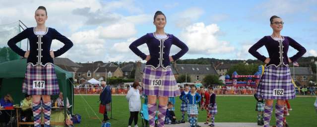 three Irish dancers on a stage