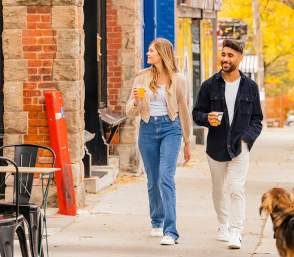 Couple walking down sidewalk in downtown Ann Arbor