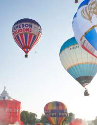 A group of balloons lifting off in a mass ascent at Bristol International Balloon Fiesta - credit Paul Box