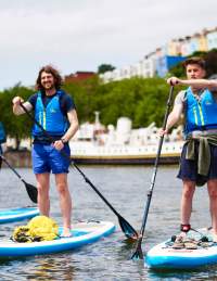 Group on paddelboards in Bristol harbour - credit SUP Bristol