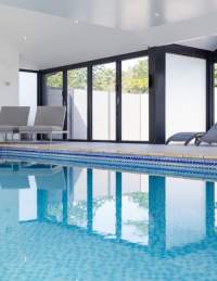 Indoor pool with loungers at Foxhills Spa - credit Old Down Estate