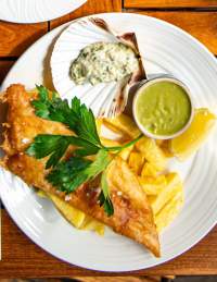 Plate of fish with chips, mushy peas and tartare sauce - credit Noah's Bristol