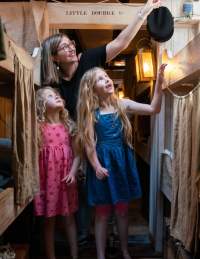 A family exploring the steerage section inside Brunel's SS Great Britain, Bristol - credit Brunel's SS Great Britain