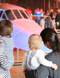 Two mothers and their children looking at the nose of Concorde Alpha Foxtrot in the Concorde Hangar at Aerospace Bristol - credit Aerospace Bristol