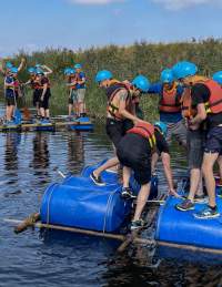 A group of men trying raft building at Mendip Activity Centre near Bristol - credit Mendip Activity Centre