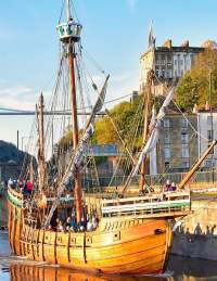 A view of The Matthew replica ship passing through Bristol's Cumberland Basin with the Clifton Suspension Bridge in the background - credit Nick Greville