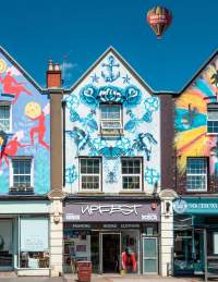 Upfest Shop Bedminster exterior. Six Sisters mural artist Gemma Compton