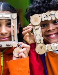 Two children taking part in a photo frame decorating activity at Westonbirt Arboretum near Bristol - credit Johnny Hathaway