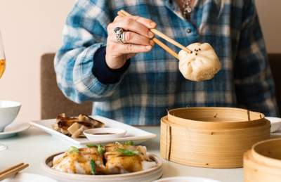 Person with dumpling on chopsticks - credit Clouds Bristol