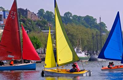 Three colourful sailboats in the Bristol Harbourside - Credit All Aboard Watersports