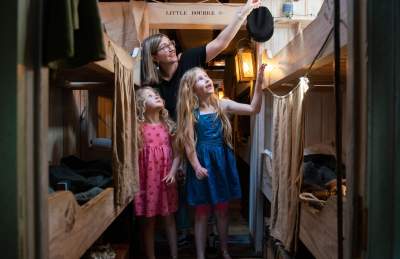 A family exploring the steerage section inside Brunel's SS Great Britain, Bristol - credit Brunel's SS Great Britain