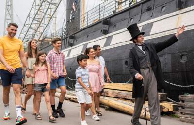 A family walking with Mr Brunel alongside the SS Great Britain in the Great Western Dockyard, Bristol - credit Brunel's SS Great Britain