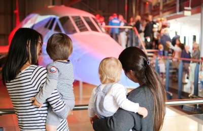 Two mothers and their children looking at the nose of Concorde Alpha Foxtrot in the Concorde Hangar at Aerospace Bristol - credit Aerospace Bristol