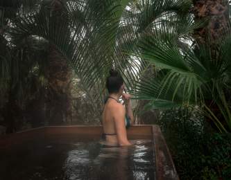 Woman relaxing in natural hot spring at Two Bunch Palms resort in Desert Hot Springs
