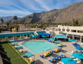 View Of The Pool With Mountains In The Background At Hotel ZOSO In Palm Springs