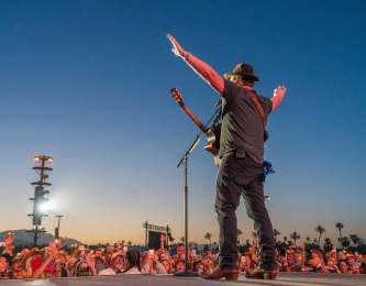 Country music star singing to large crowd at Stagecoach Music Festival.